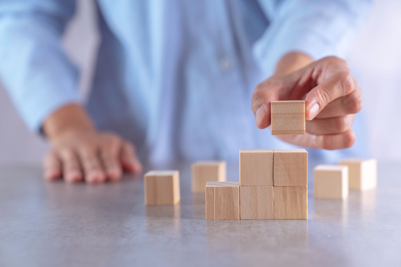 man stacking blocks