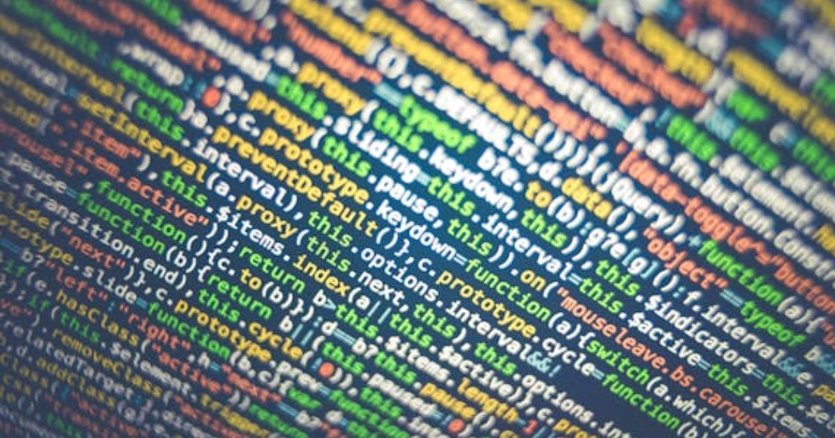Image of coding on a screen in green, white, red, and yellow.