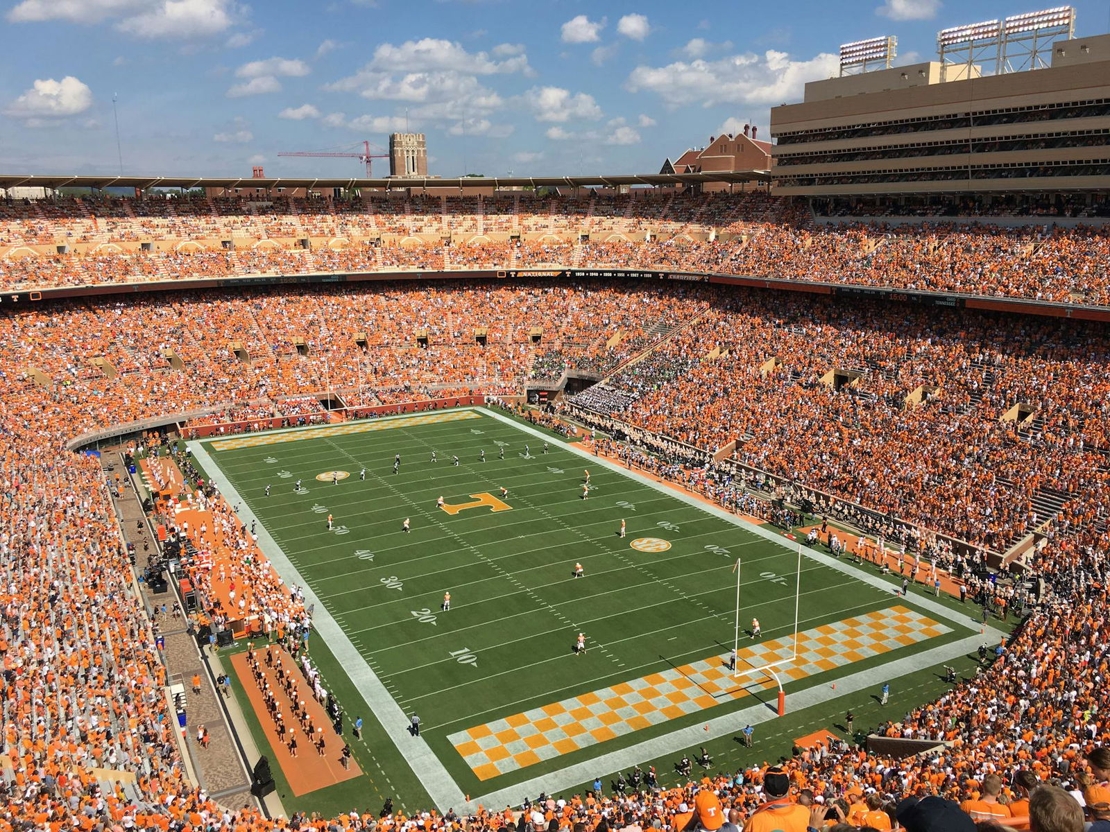A football field with thousands of fans in attendance.