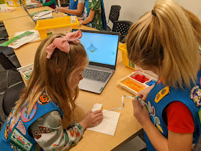 Scouts engaged in a coding activity
