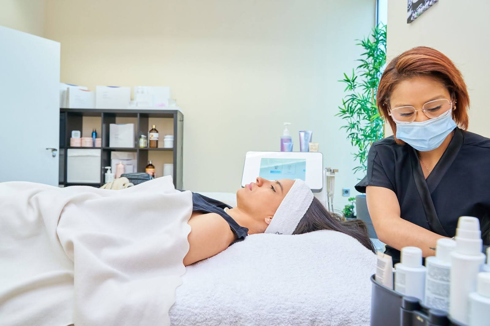 A woman is laying down on a spa bed.