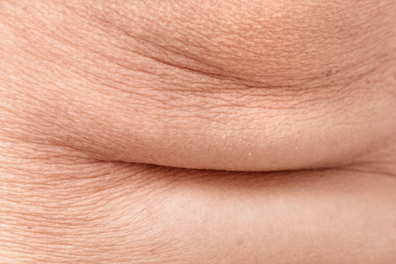 Macro view of the skin, highlighting the texture of fine lines and wrinkles.