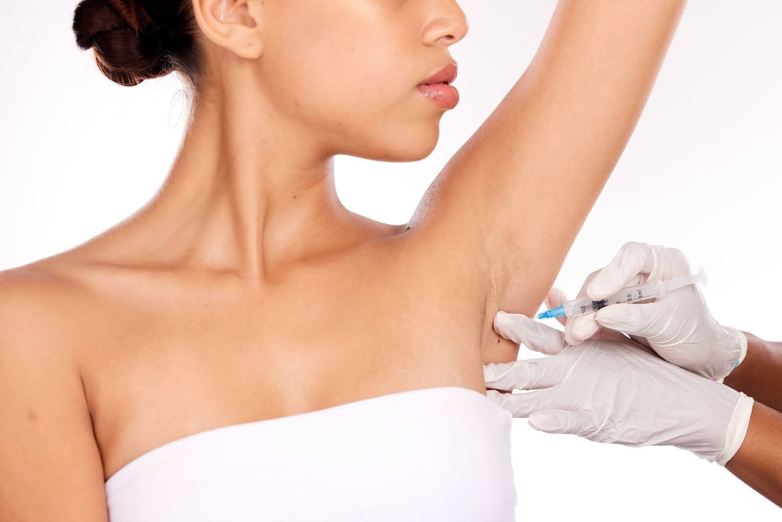 Close-up of an underarm Botox® injection administered to a woman for clinical hyperhidrosis management.