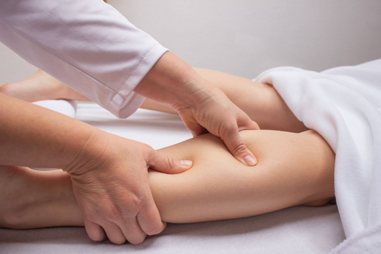Close-up view of leg massage therapy using lymphatic drainage techniques to improve circulation and comfort.