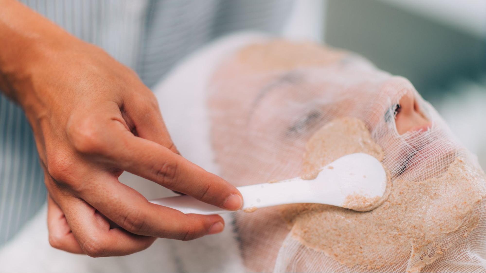 Hydrating vegetable-based facial mask applied to a client’s face following an exfoliating skincare service.