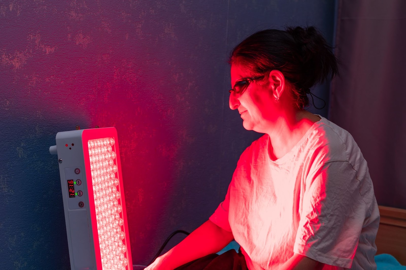Senior woman undergoing red light therapy as part of psoriasis treatment