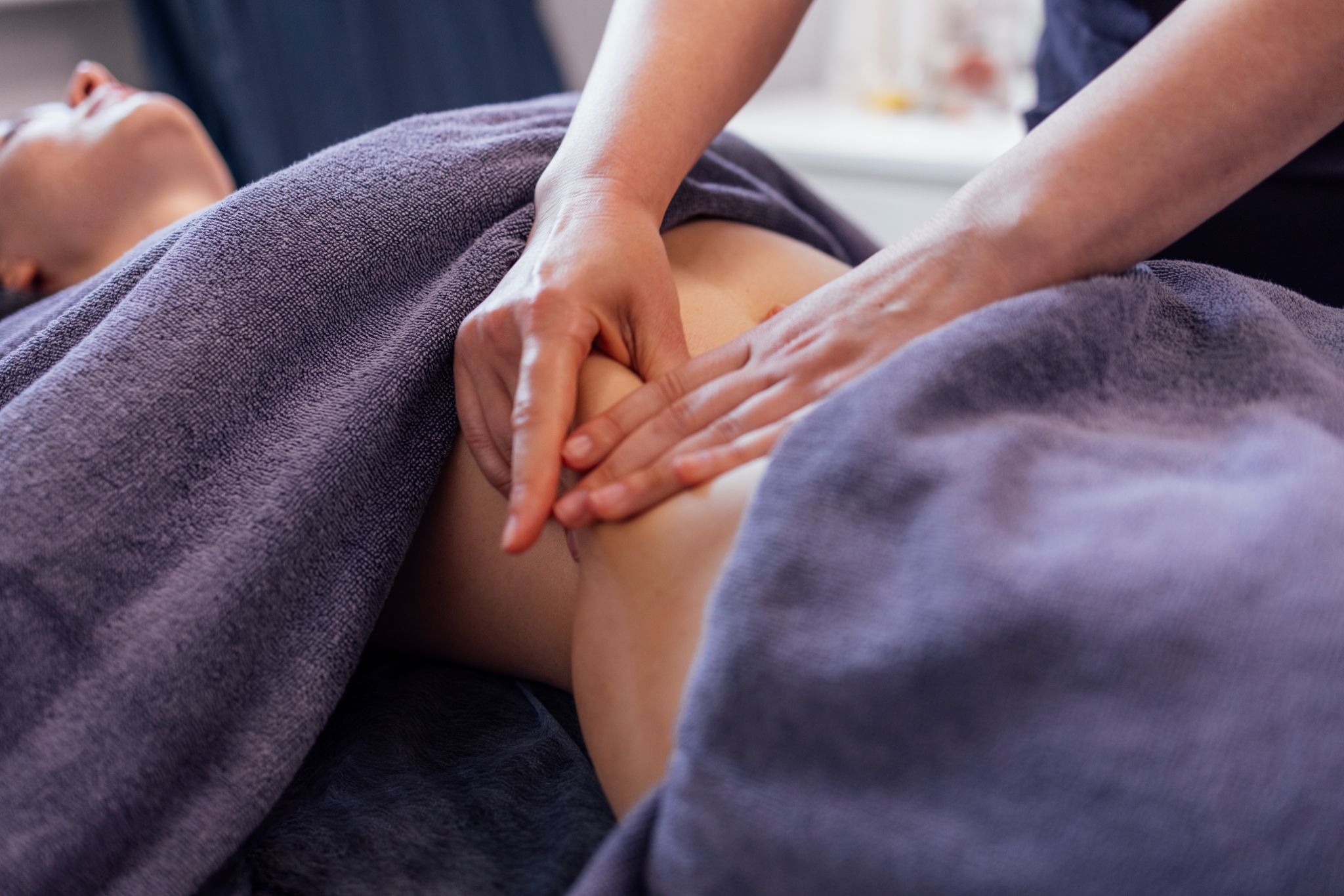 Close-up of abdominal massage to support lymphatic flow at a med spa