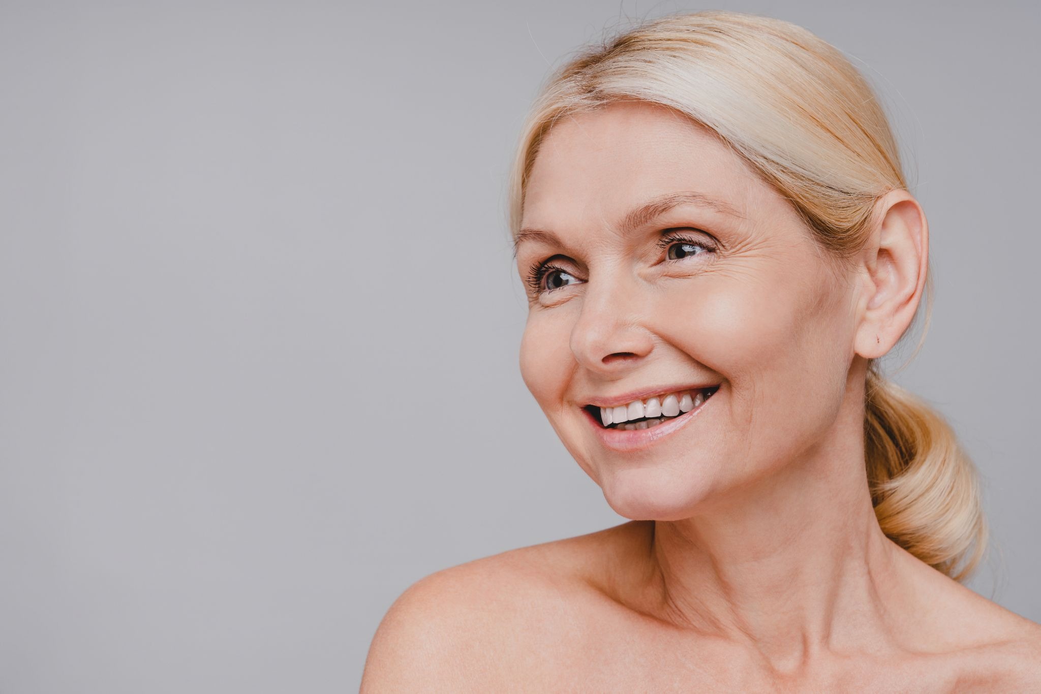 Side profile of a middle-aged woman showing smoother skin and reduced lines after microneedling