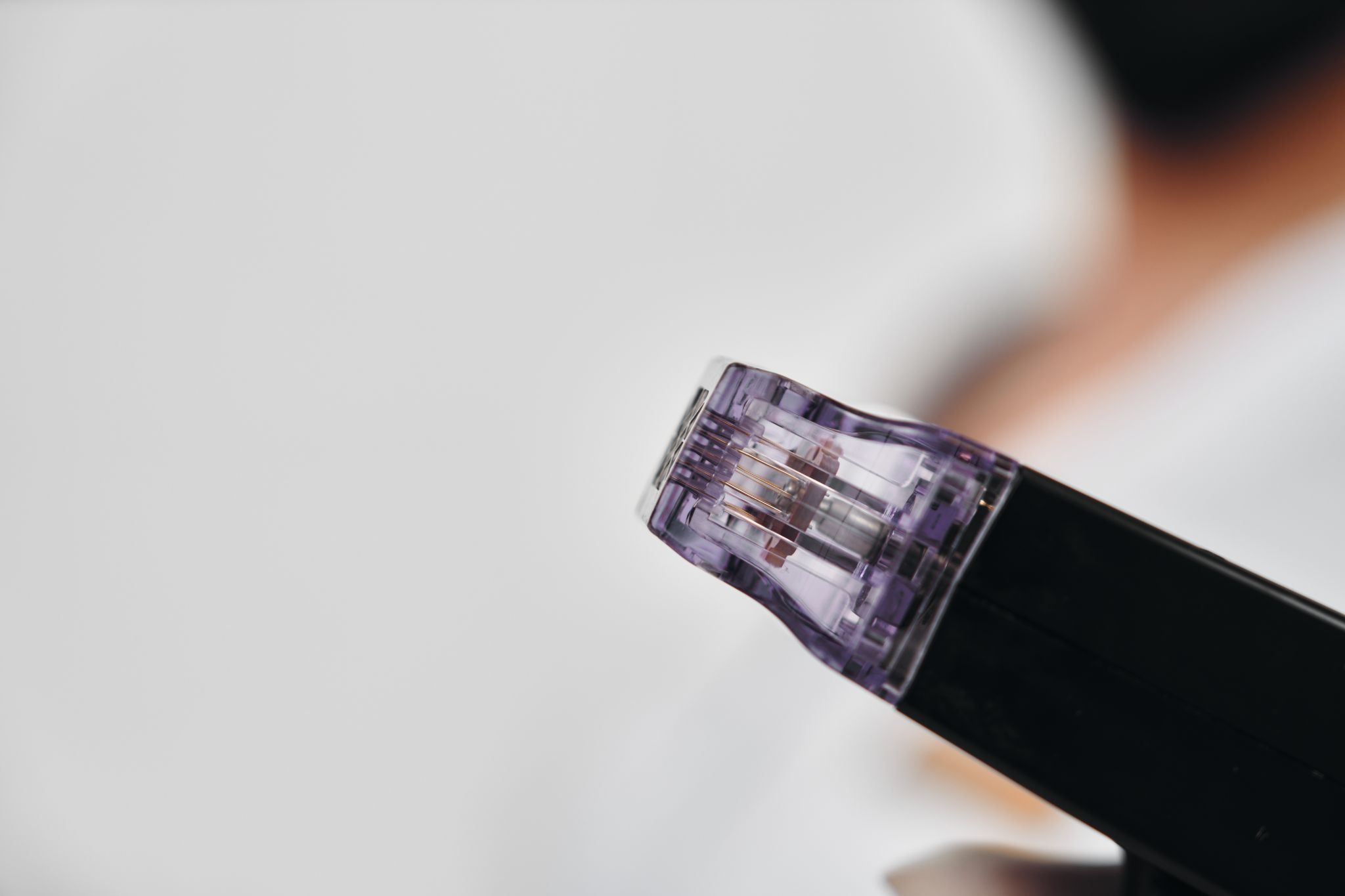 Close-up of a microneedling device with fine needles designed for skin rejuvenation