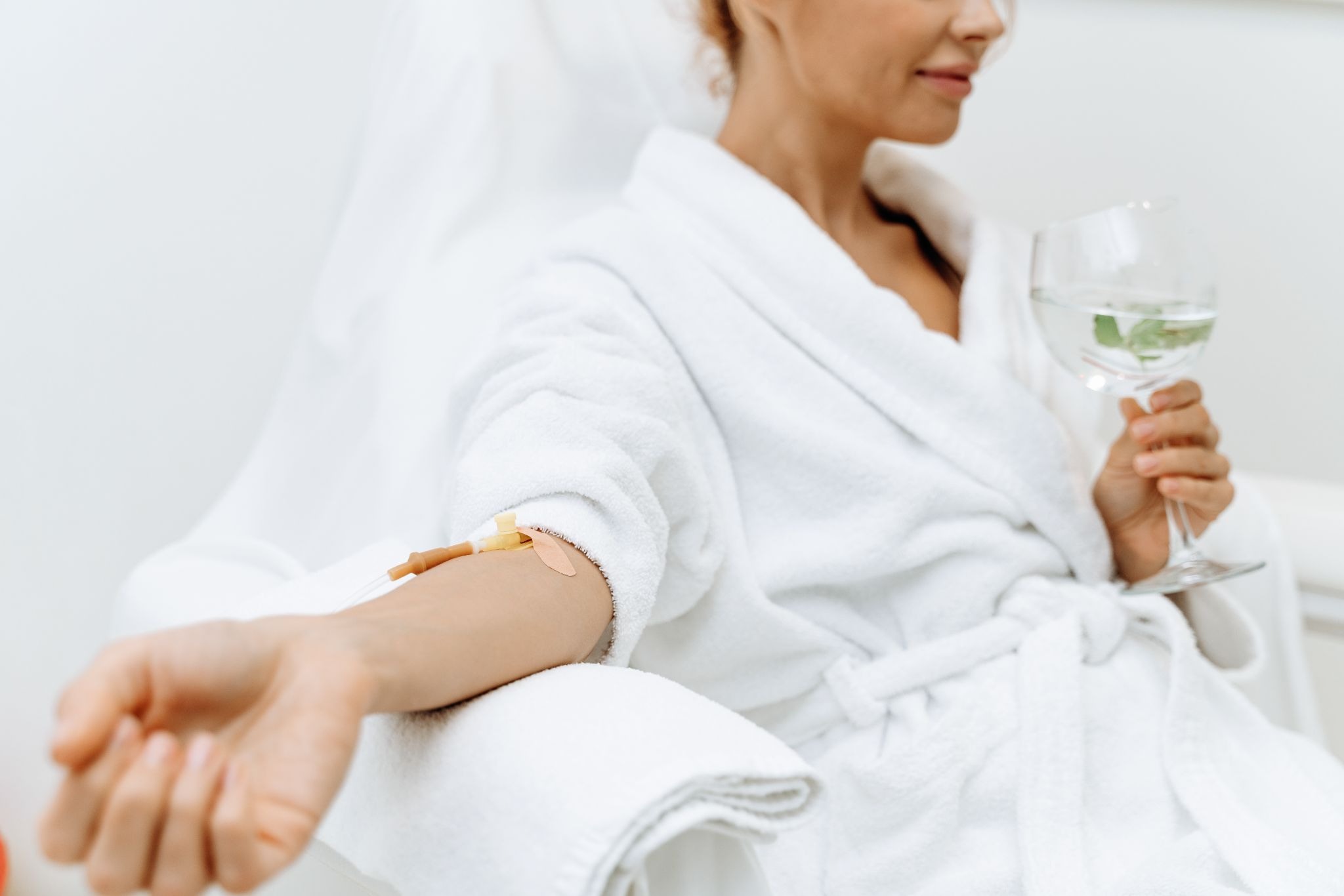 Close-up of a calm female patient receiving IV magnesium infusion