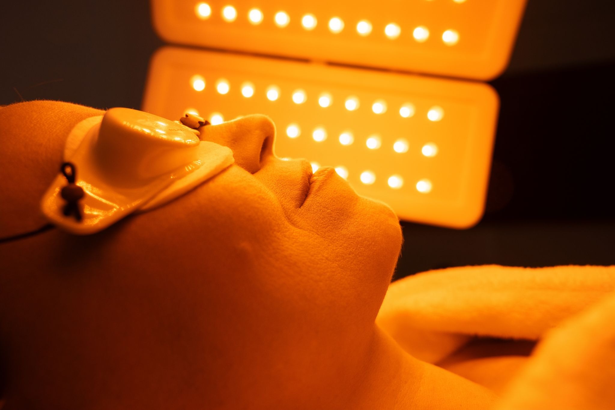 Close-up of a woman receiving LED light therapy during a skincare treatment