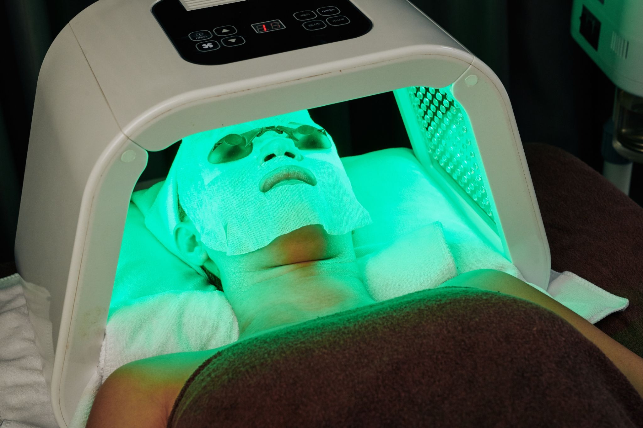 Adult wearing a mask during the green LED light therapy treatment