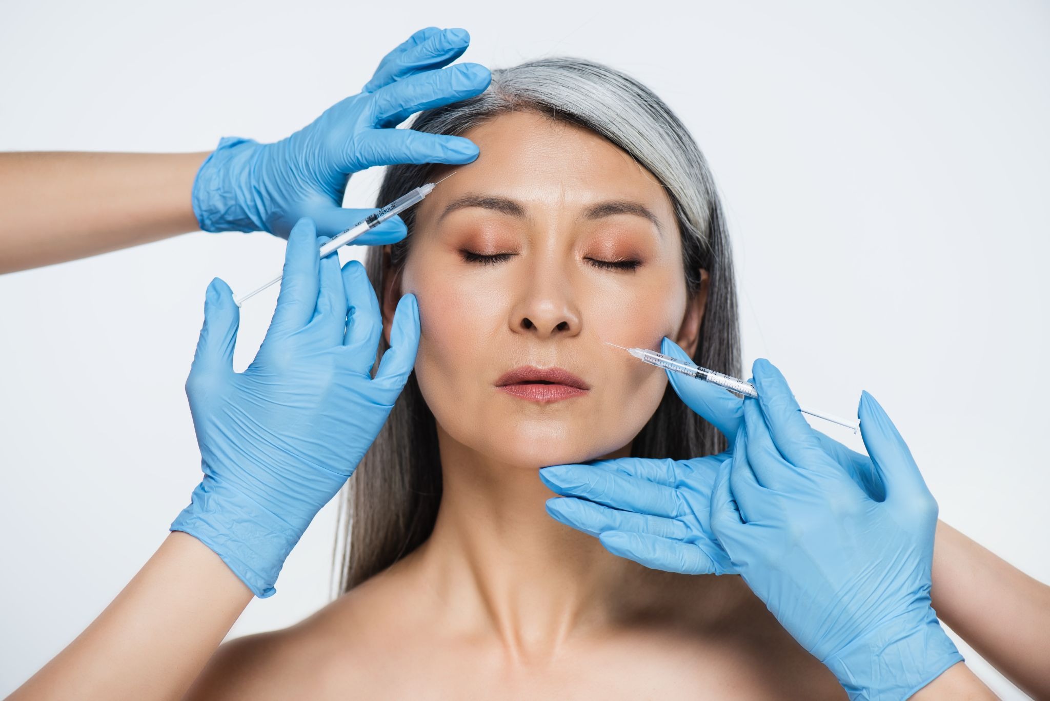 Woman receiving injectable fillers for facial rejuvenation and volume restoration