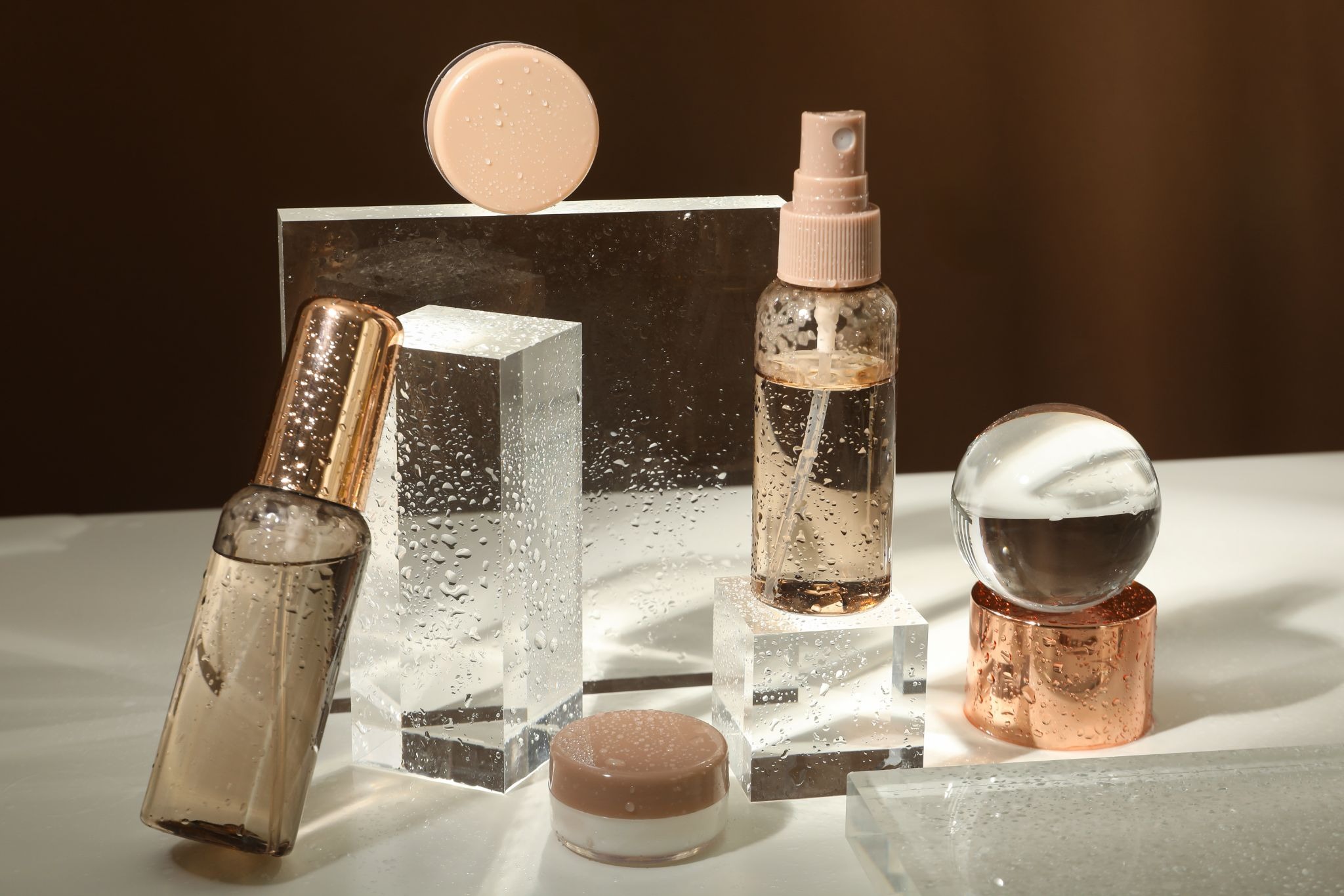 An elegant display of skincare products on geometric glass stands for achieving smooth, healthy-looking skin