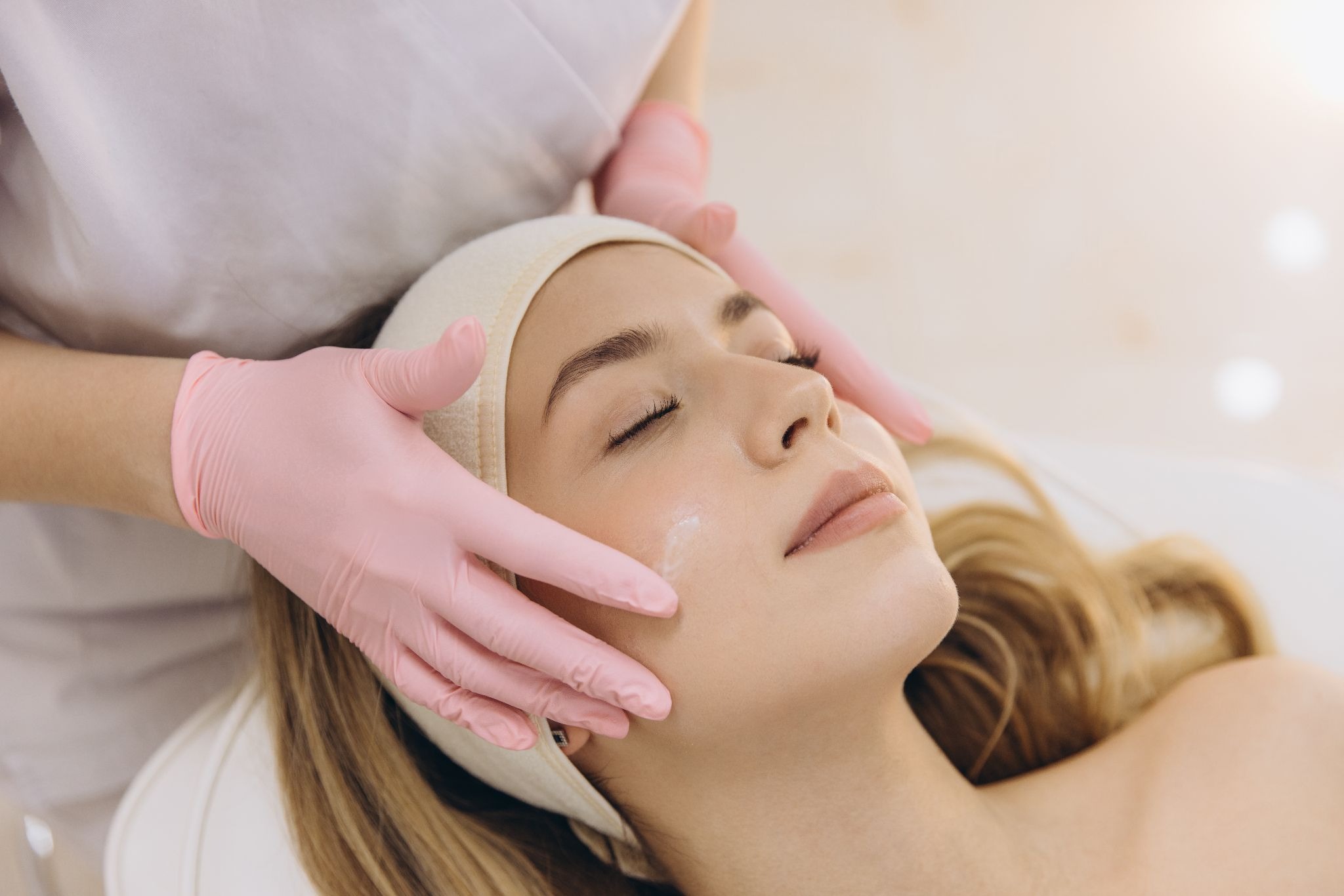 Woman receiving a professional facial treatment to promote smooth, healthy-looking skin