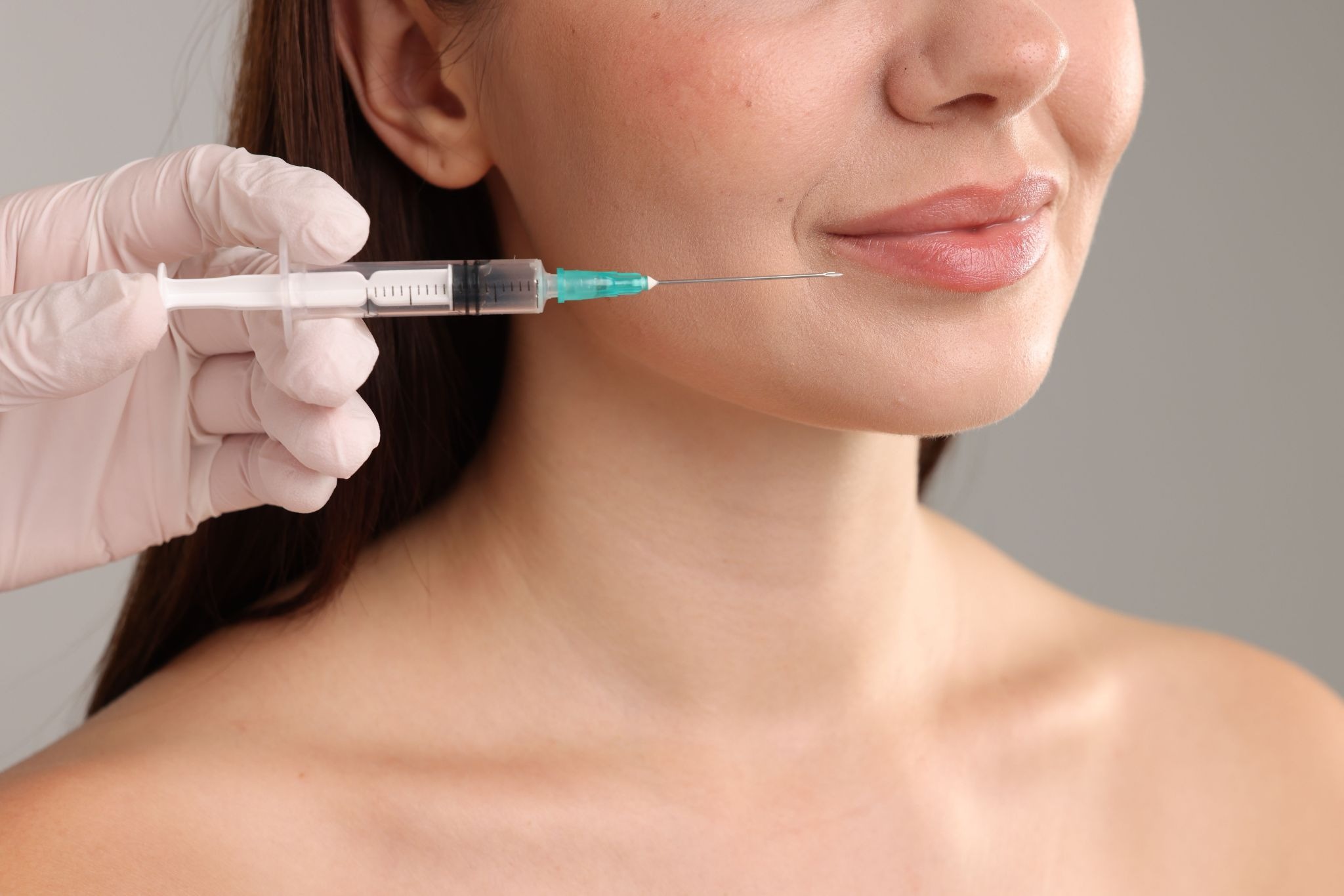 Woman after receiving a lip filler injection in a med spa