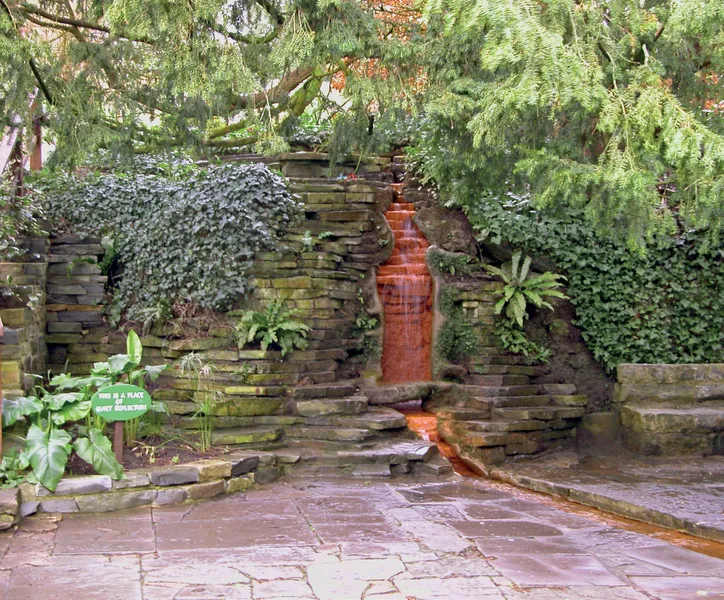 The blood-red stream flowing from the sacred spring in the Chalice Well gardens