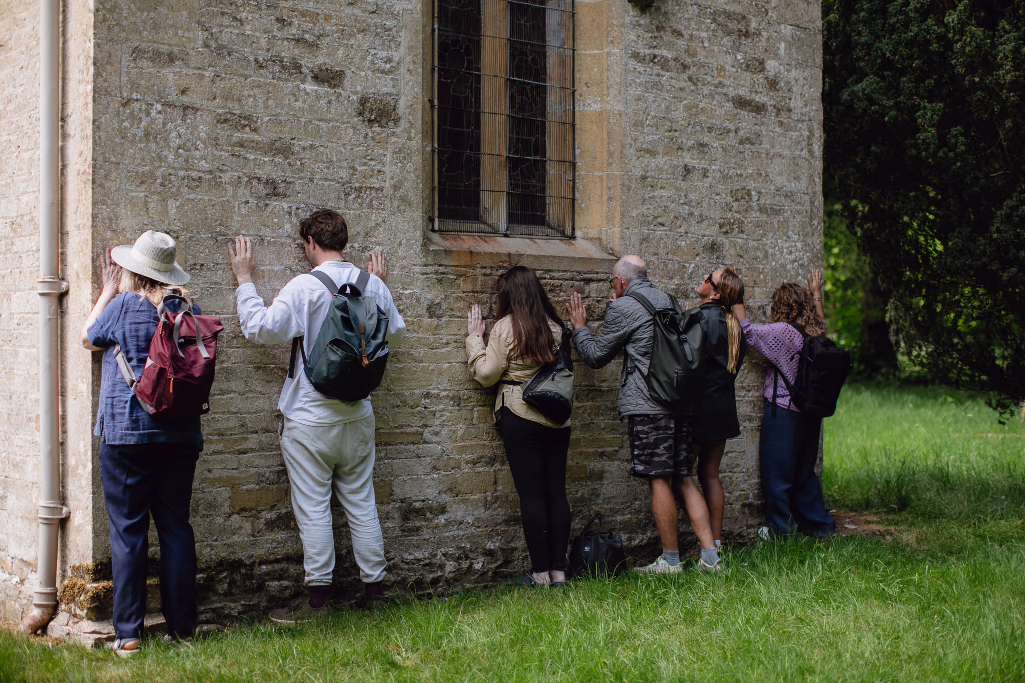 Rest your forehead on the outside of the east wall of a church or cathedral. You will be standing directly behind the altar. 