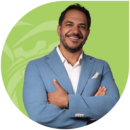 Smiling Dr. Hessam Rahimi with short hair and beard wearing a blue suit jacket and light blue shirt, giving a thumbs up.
