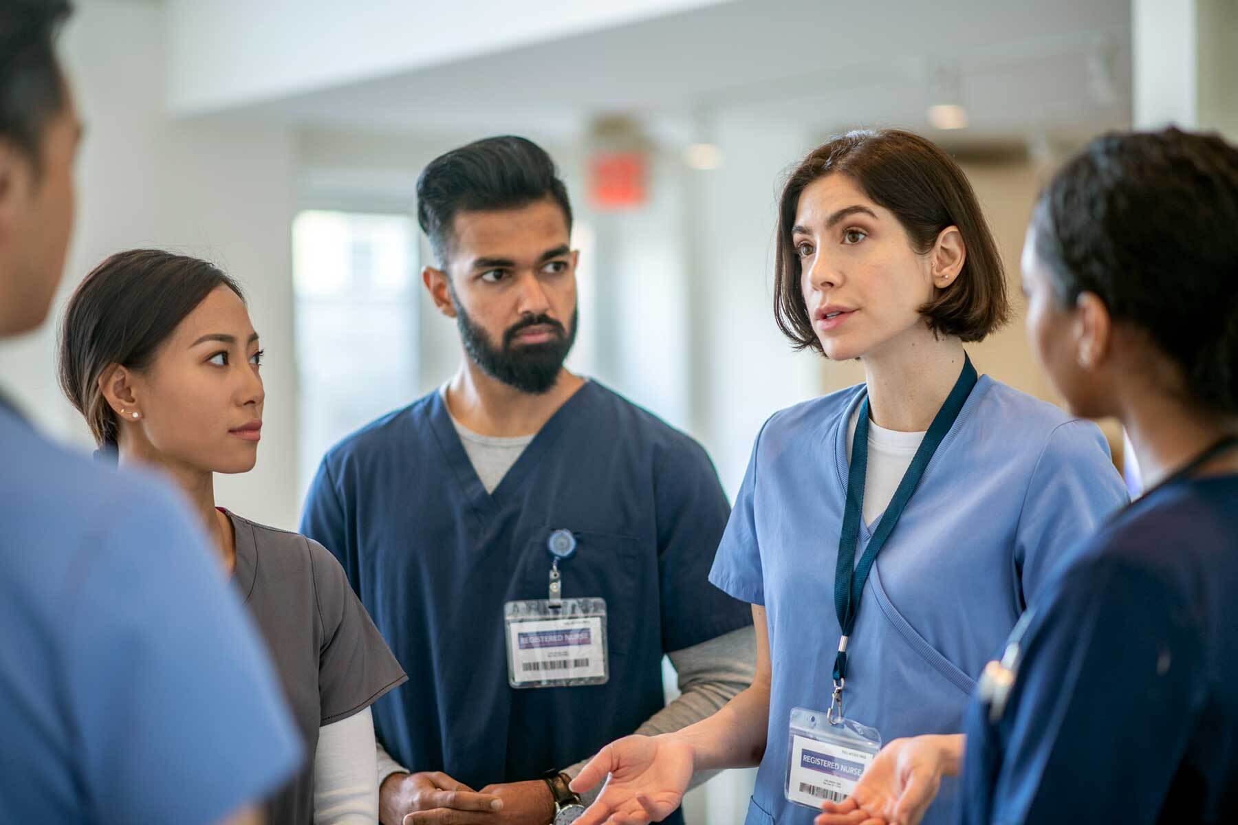 Group-of-nurses-in-scrubs-talking