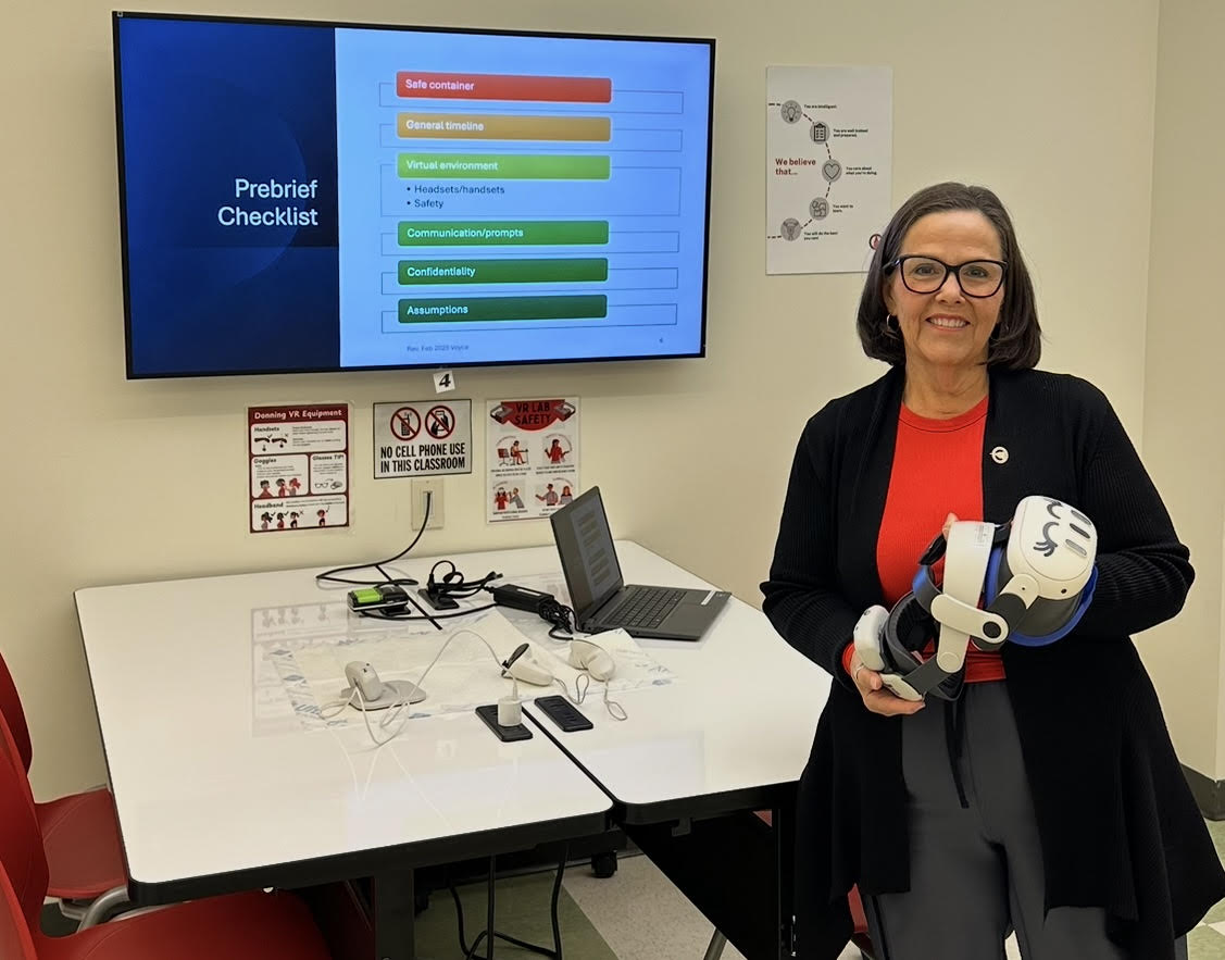 Dr. Cynthia Voyce of UIW holding a UbiSim VR headset