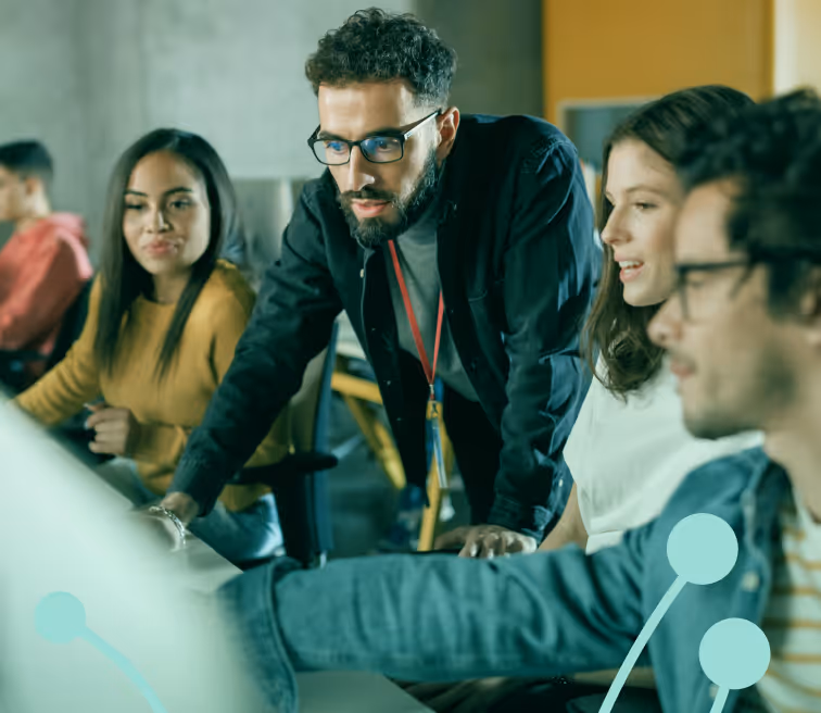 Team of diverse young professionals collaborating and focused on a computer screen in an office.
