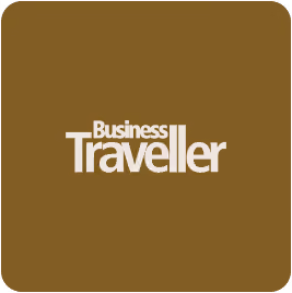 Business Traveller logo with white text on a brown rounded square background.