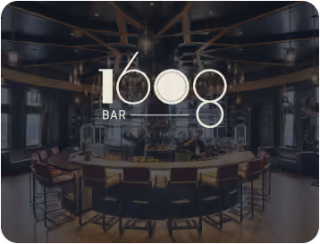 Interior of 1608 Bar featuring a circular bar counter with stools and dim ambient lighting.