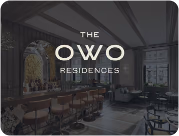 Modern lounge area with bar stools, tables, and seating at The OWO Residences.