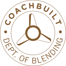 Brown circular Coachbuilt Dept. of Blending emblem featuring a three-spoke propeller design in the center.