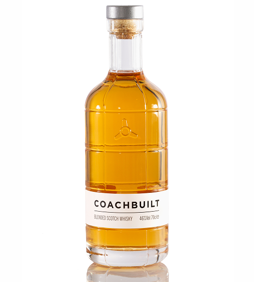 Clear glass bottle of Coachbuilt blended Scotch whisky with amber liquid and a white label.