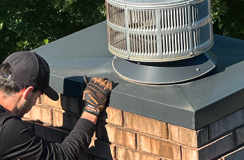 Professional chimney inspection performed by a certified technician on a residential roof