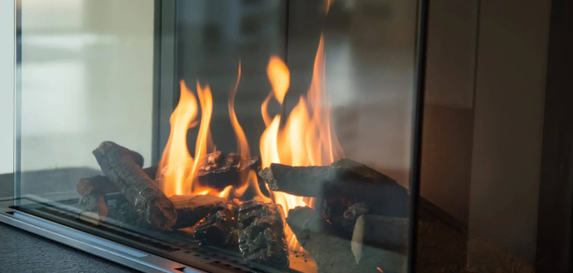 Gas fireplace operating after repair with clean burner flames and proper ignition