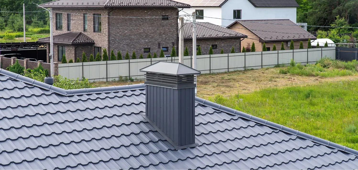 Installed chimney cap protecting the flue from water, debris, and animals