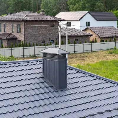 Installed chimney cap protecting the flue from water, debris, and animals