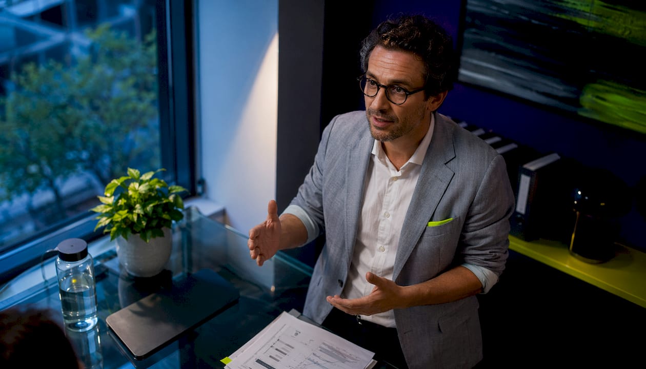 Researcher taking notes at home study desk