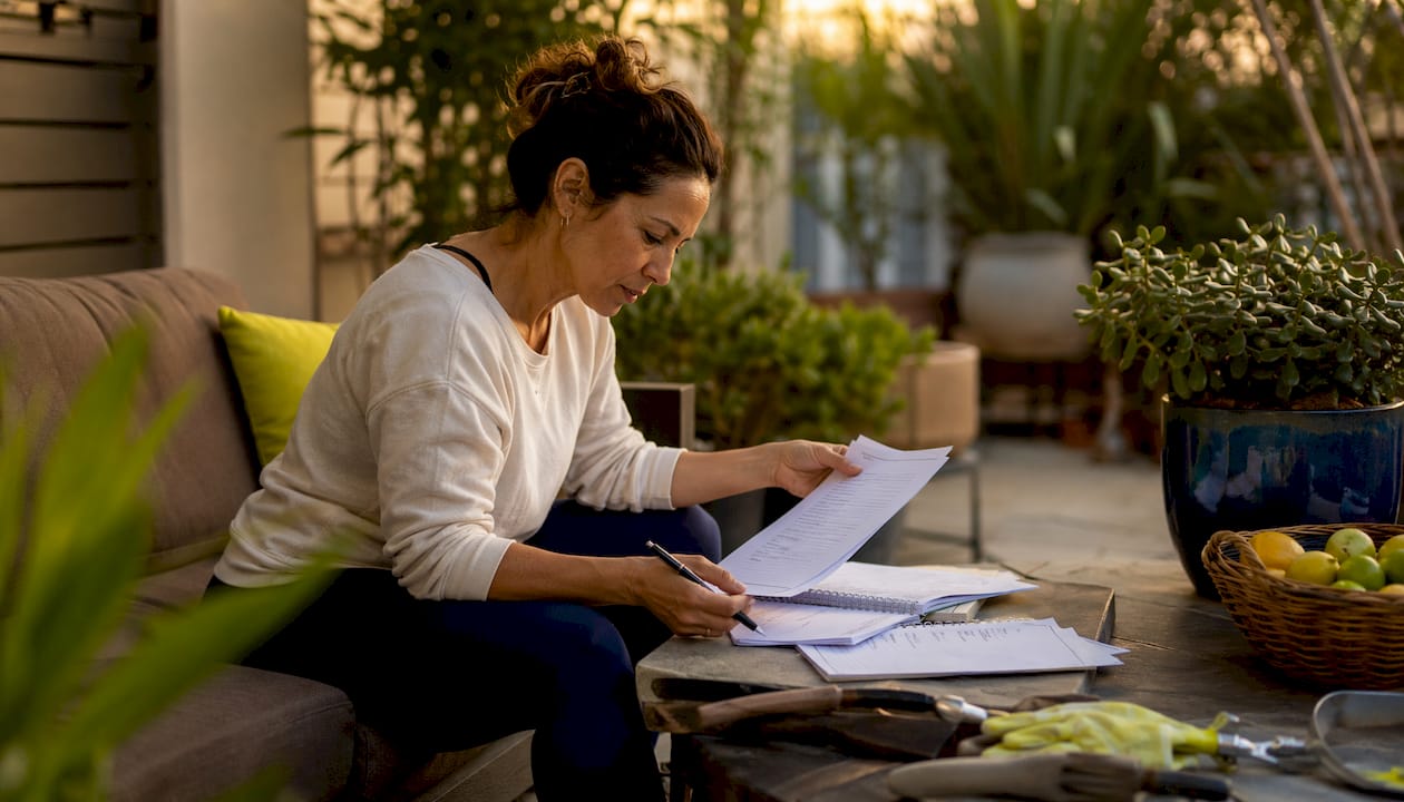 Woman reviewing yoga studio choices at home table