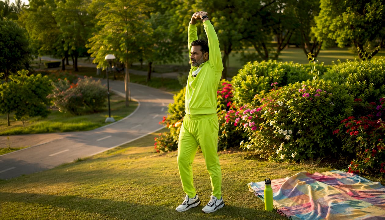 Man doing dynamic warm-up stretches