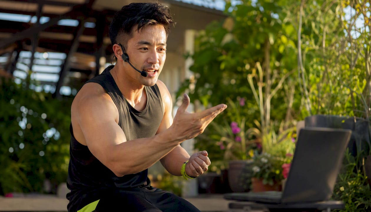 Fitness trainer coaching live workout session