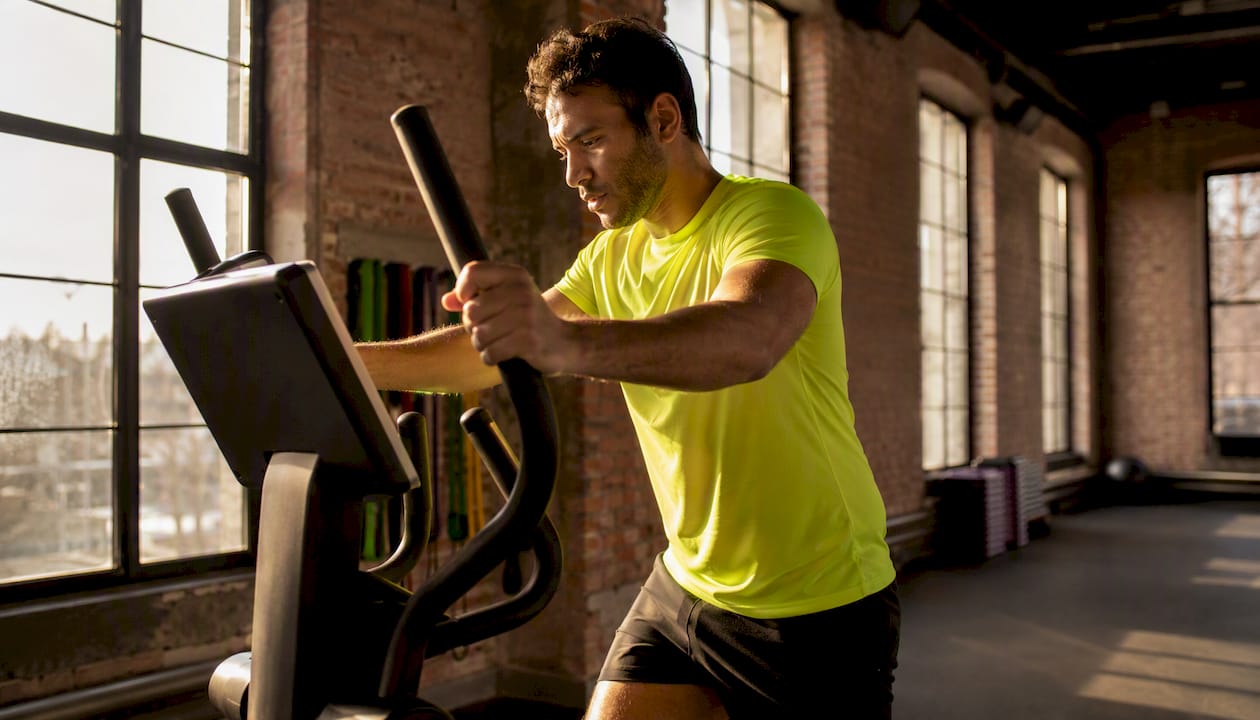 Man doing elliptical low-impact cardio workout