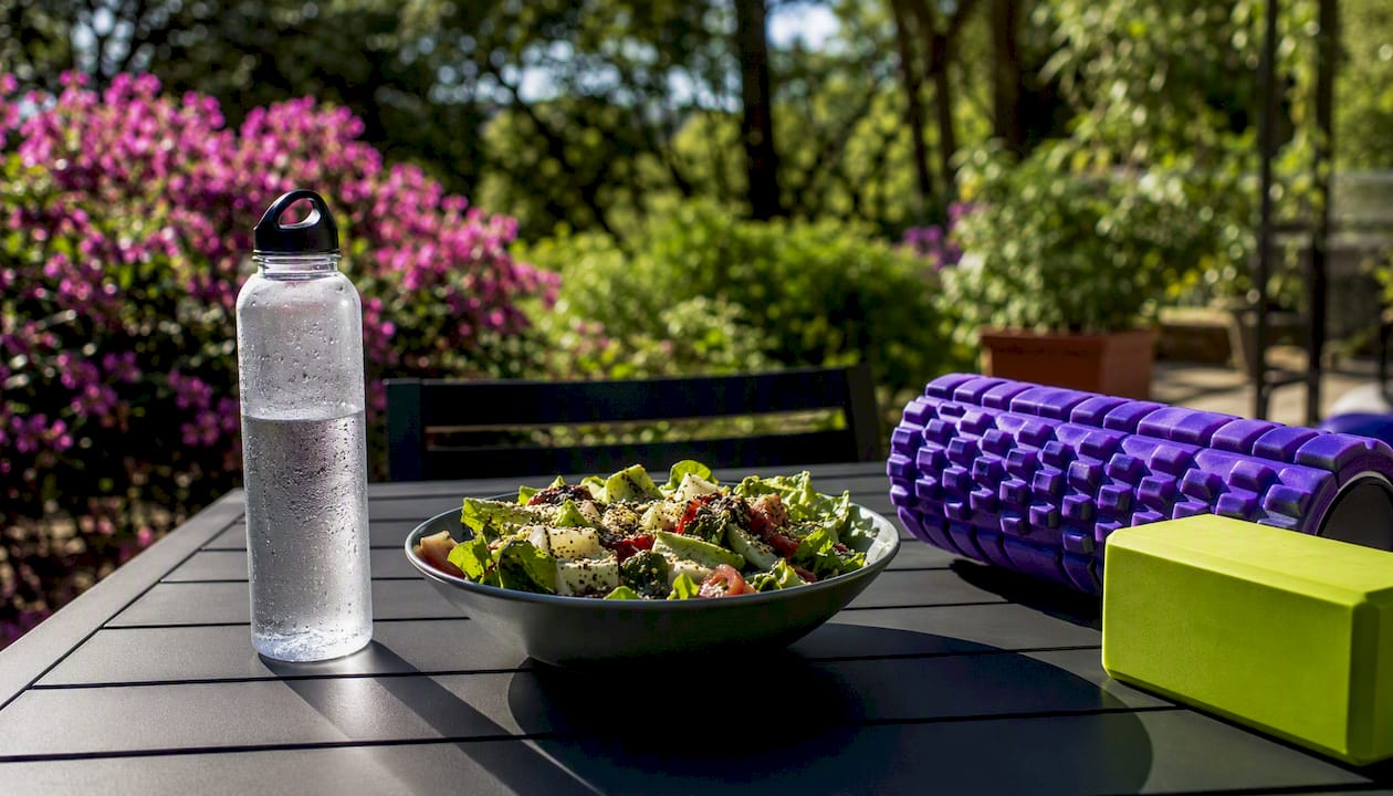 Fresh salad and water for workout recovery