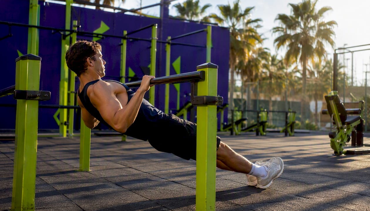 Person performing inverted row under bar
