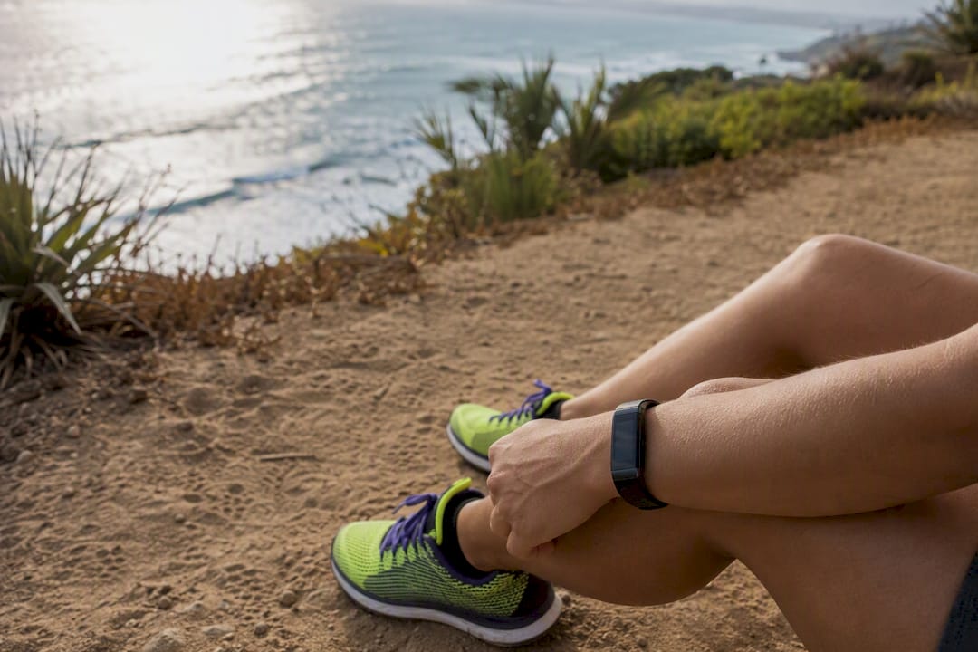 Running shoes and wrist heart rate monitor close-up