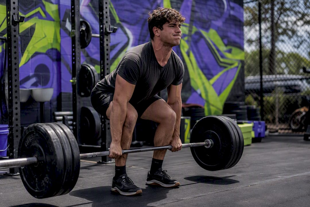 Young adult deadlifting in modern gym