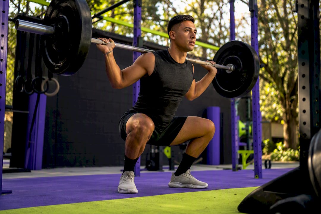 Weightlifter performing barbell back squat