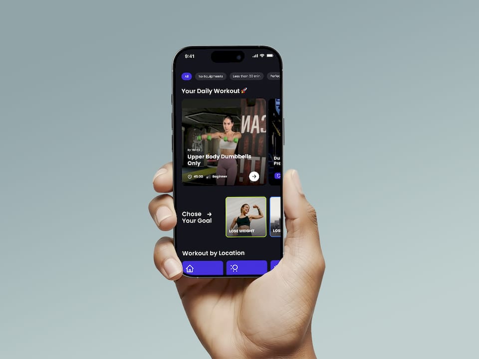 Hand holding a smartphone displaying the Onemor app with a daily workout, upper-body dumbbell exercise, workout goals, and location options.
