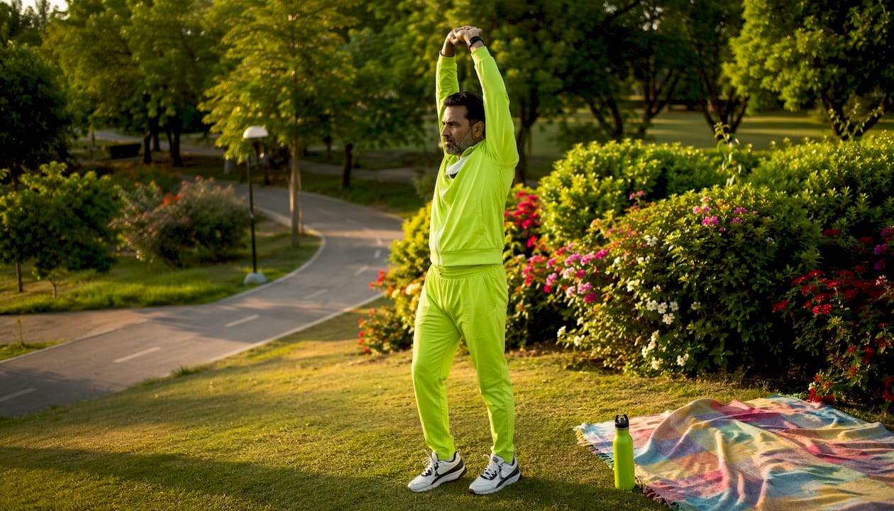 Man doing dynamic warm-up stretches