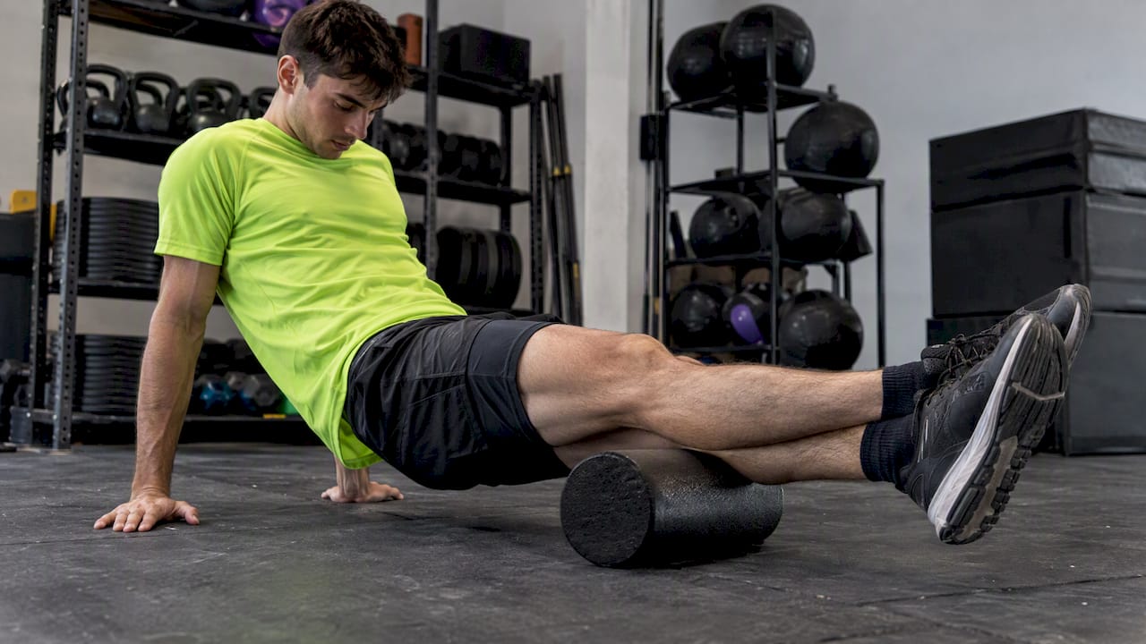 Athlete using a foam roller after training