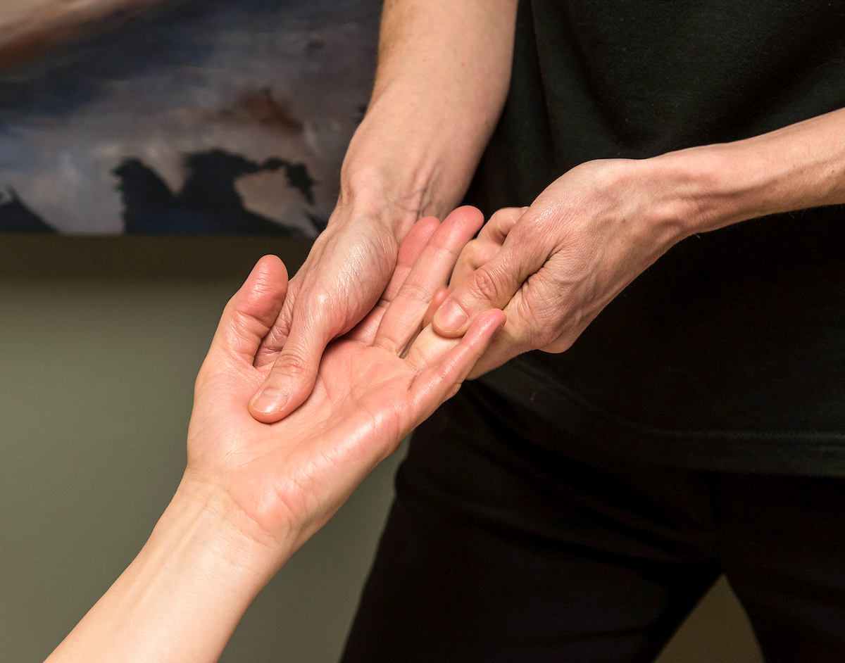 Person massaging hand