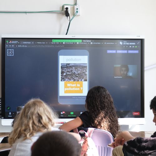 Students looking at digital board.